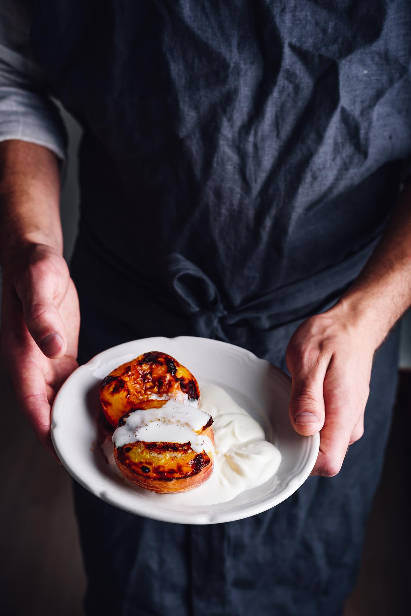Chef preparing a plated dish in a calm studio